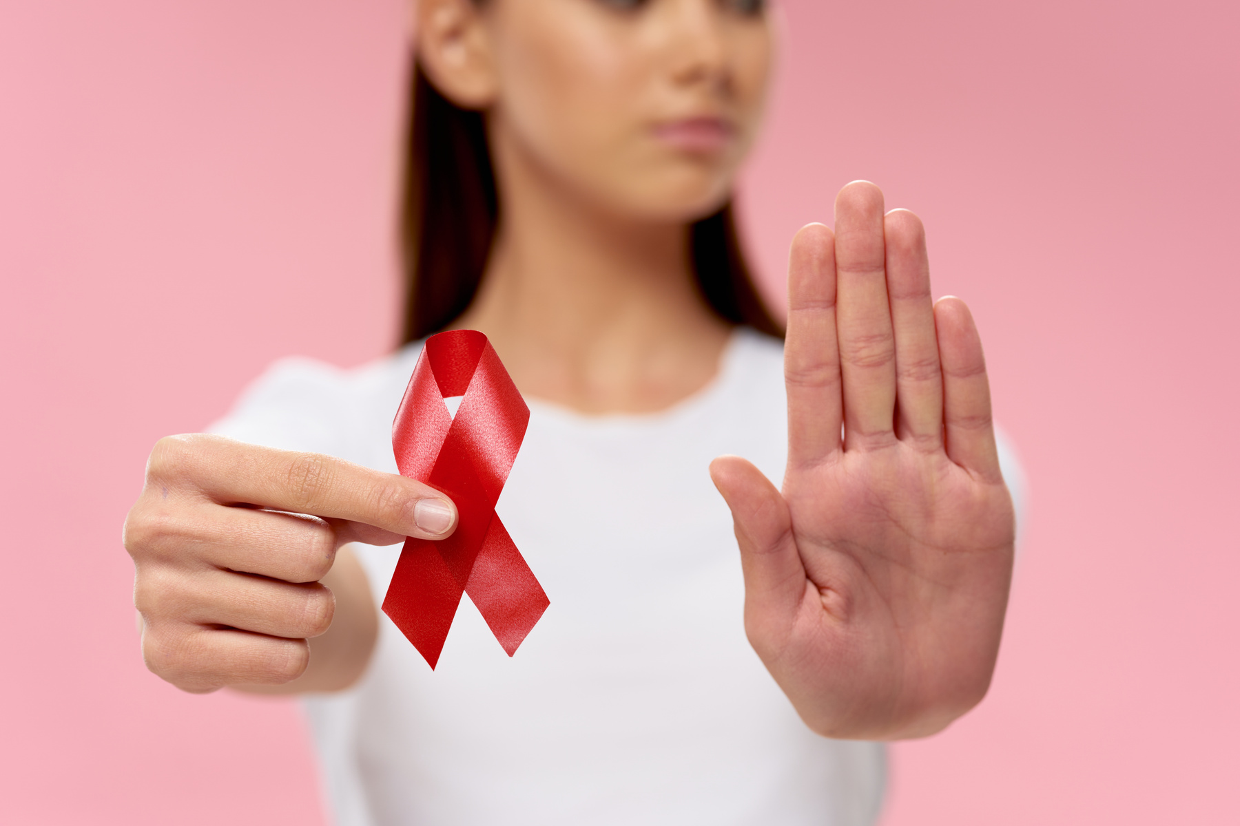 Woman with Red Ribbon in Hands on Pink Background Charity Foundation
